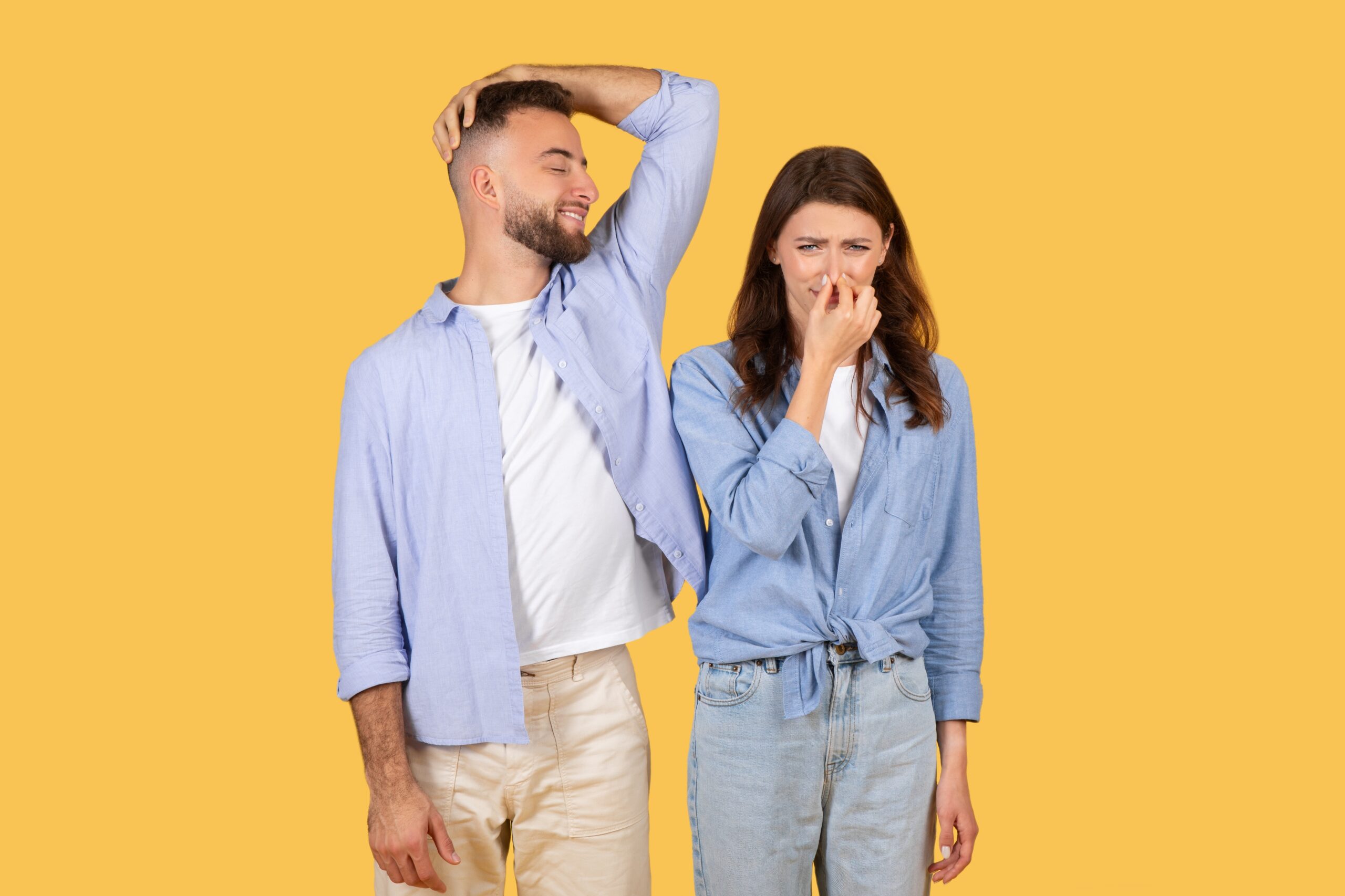Man,Humorously,Sniffs,His,Armpit,And,Smiles,,While,Woman,Next
